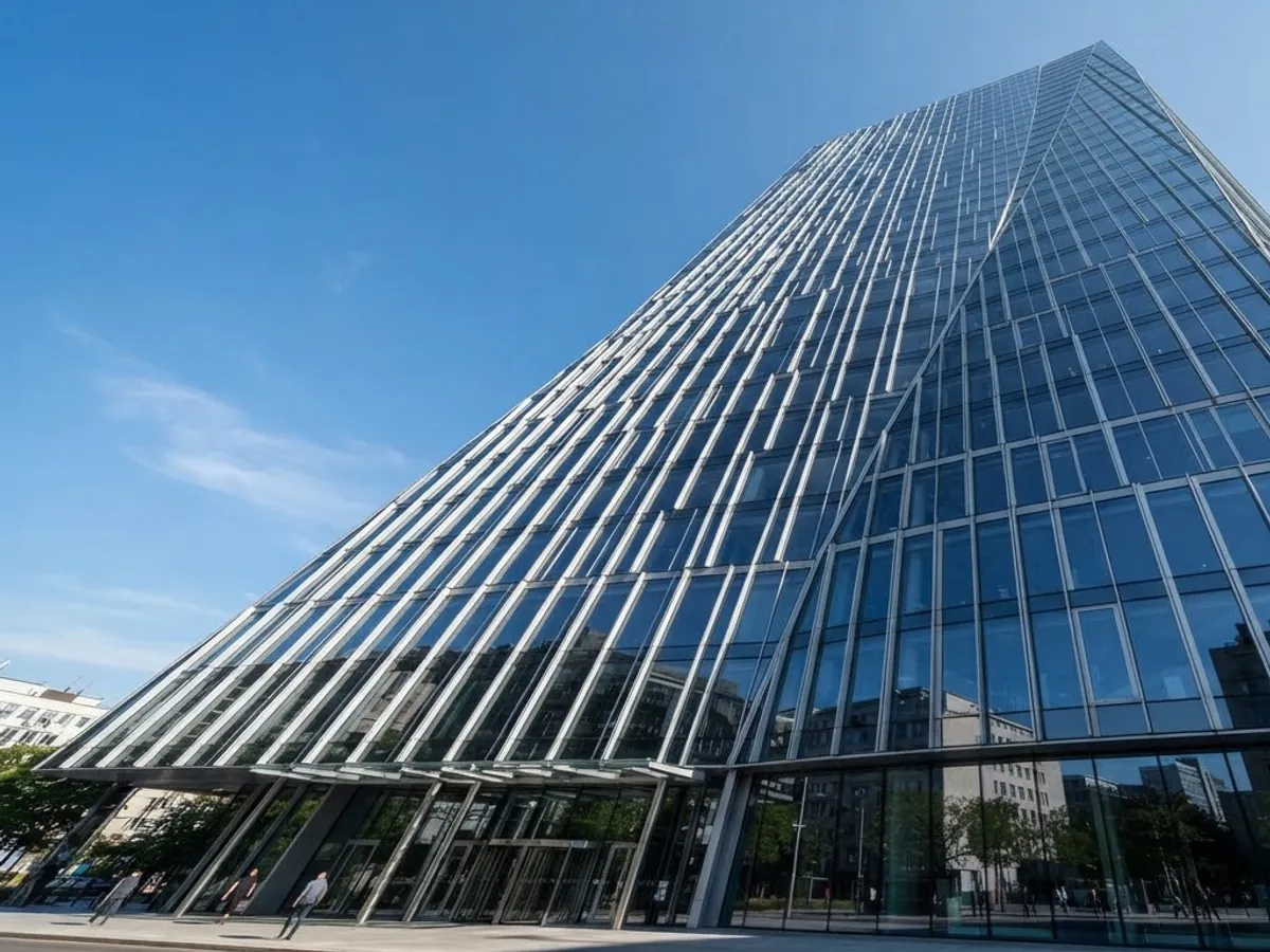 Low-angle view of a glazed curtain wall with a regular aluminium grid.